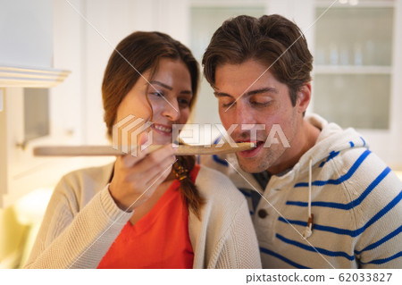Young couple cooking together at home 62033827