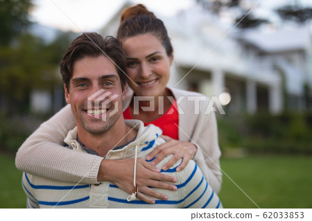Happy young couple holding each other in the garden 62033853