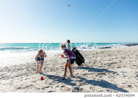 Brother and sisters having fun at the beach Brother and sisters having fun at the beach 62034094
