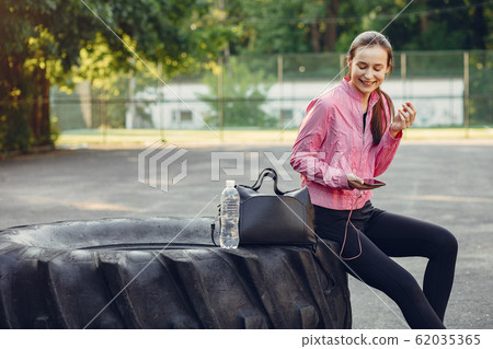 Sports girl training ain a summer park 62035365