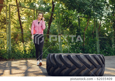 Sports girl training ain a summer park Sports girl training ain a summer park 62035409