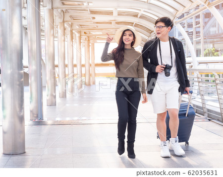 Happy asian couple tourist sightseeing in the city. Couple on honeymoon day. 62035631