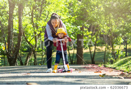 Cute little child girl having fun to riding a Cute little child girl having fun to riding a 62036673