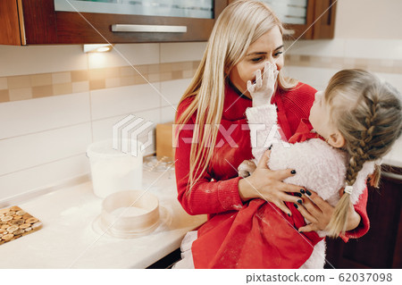 Cute family prepare the breakfest in a kitchen Cute family prepare the breakfest in a kitchen 62037098