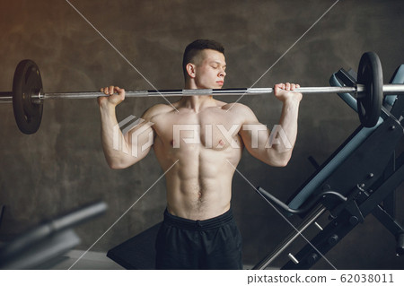 A handsome man is engaged in a gym 62038011