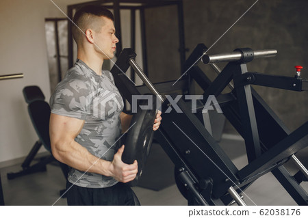 A handsome man is engaged in a gym 62038176