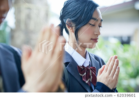 High school couple visiting a shrine High school couple visiting a shrine 62039601