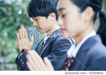 High school couple visiting a shrine High school couple visiting a shrine 62039603