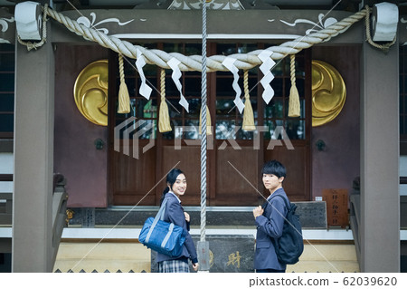 High school couple visiting a shrine High school couple visiting a shrine 62039620