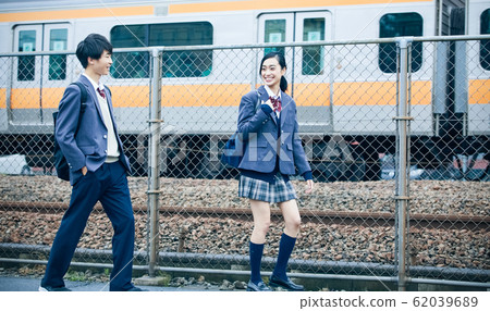 High school couple going to and from school High school couple going to and from school 62039689