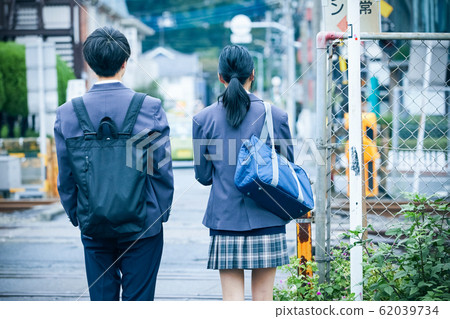 High school couple going to and from school 62039734