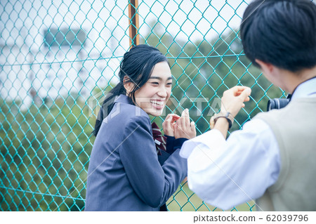 High school couple taking pictures 62039796