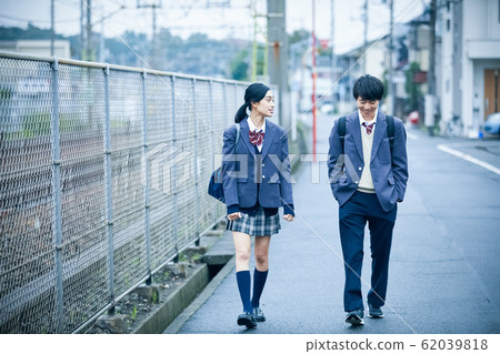 High school couple going to and from school High school couple going to and from school 62039818