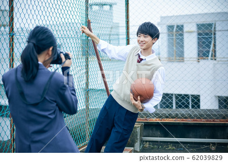 High school couple taking pictures High school couple taking pictures 62039829