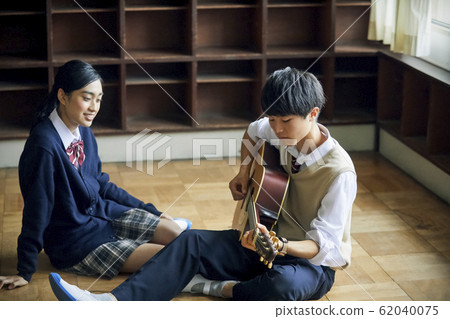 High school student playing guitar 62040075