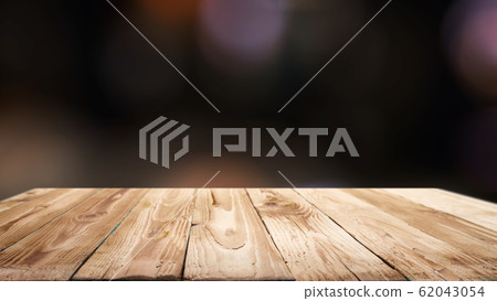 Wooden surface on blurry black background . Wooden surface on blurry black background . 62043054