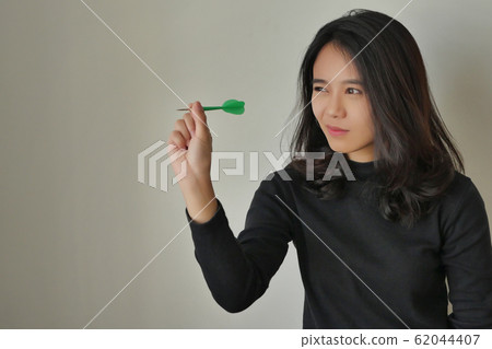 woman aiming dart, concept of target or goal 62044407