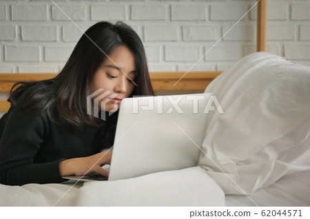 unhappy surprised upset woman working with laptop 62044571