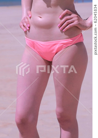 Woman slim body in bikini pants tummy and legs sea sand beach sunbath vacation. 62045834