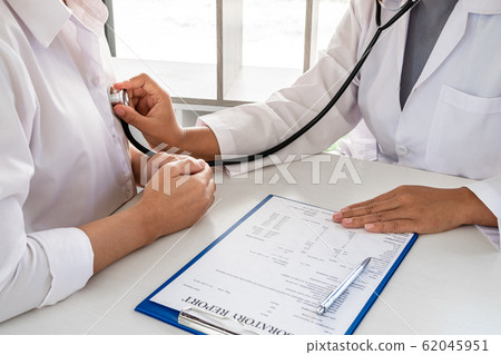 Female doctors perform a pulse examination using a stethoscope. Initial health check up at the hospital Concepts of treatment and good health 62045951