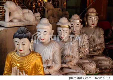 carving Buddha statues from stone in a street carving Buddha statues from stone in a street 62046983