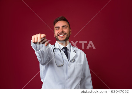 Young handsome modern doctor in a white medical 62047062