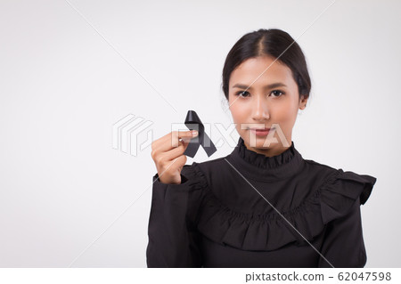 sad woman hand holding black ribbon bow, sad 62047598