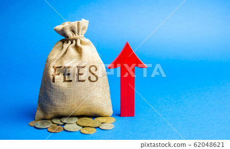 Money bag with the word Fees and up arrow. Duty increase concept. Trade wars. Import and export quotas. High taxation. Free trading zone. Business and Finance 62048621