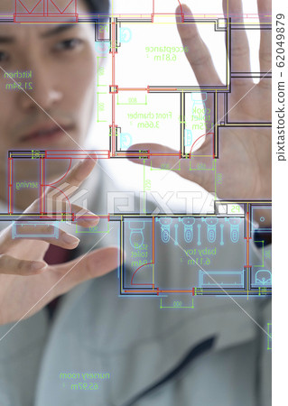 A male businessman in a state-of-the-art first-class architect office that projects drawings on an aerial display and performs presentation operations 62049879
