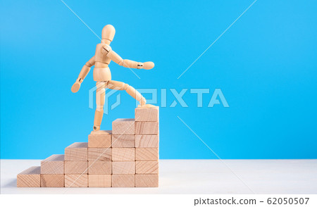 Wooden man walk up the career stairs. Wooden man walk up the career stairs. 62050507