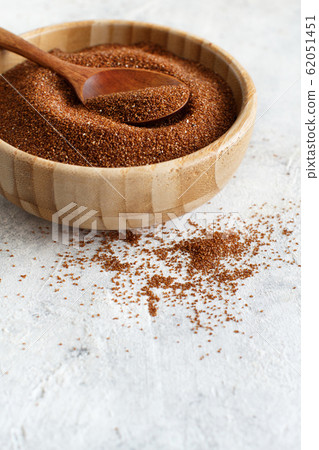 Raw teff grain in a wooden bowl close up Raw teff grain in a wooden bowl close up 62051451
