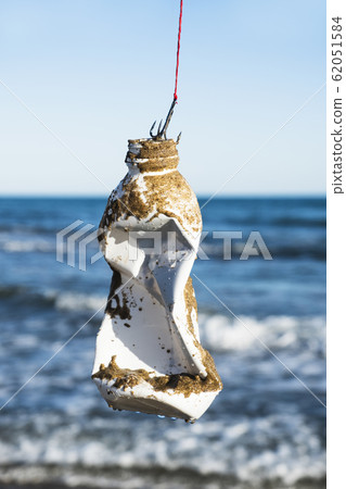 used plastic bottle in a fish hook. used plastic bottle in a fish hook. 62051584