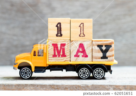 Truck hold letter block in word 11may on wood background  62051651