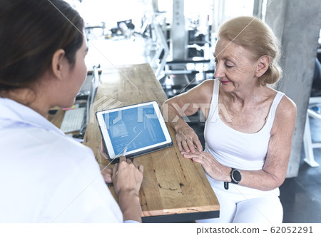 Doctor with senior woman in rehabilitation center Doctor with senior woman in rehabilitation center 62052291