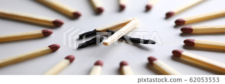 Broken burned out match in surrounded by evil intact fellows 62053553