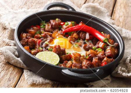 Sizzling spicy pork sisig with egg ang lime Sizzling spicy pork sisig with egg ang lime 62054928