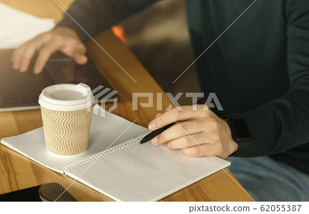 Unrecognizable Guy Working Taking Notes In Modern Office, Cropped, Closeup Unrecognizable Guy Working Taking Notes In Modern Office, Cropped, Closeup 62055387