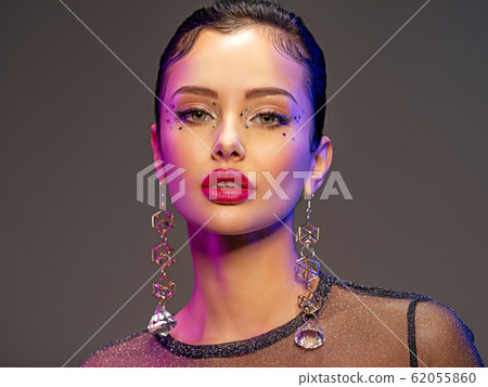 Portrait of beautiful young woman with bright 62055860