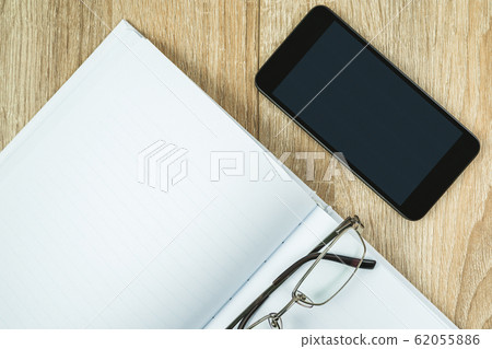 Blank notebook diary with cellphone and glasses Blank notebook diary with cellphone and glasses 62055886