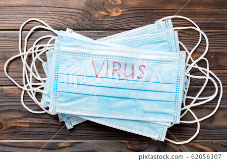 virus word written on medical mask. virus text on virus word written on medical mask. virus text on 62056307