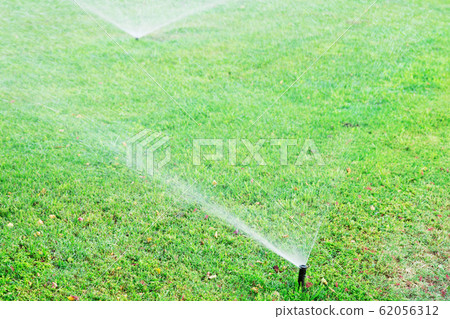 Sprinkler in garden watering the lawn. Automatic Sprinkler in garden watering the lawn. Automatic 62056312