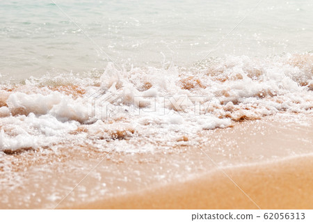 Powerful blue wave breaks along the shore. Close Powerful blue wave breaks along the shore. Close 62056313