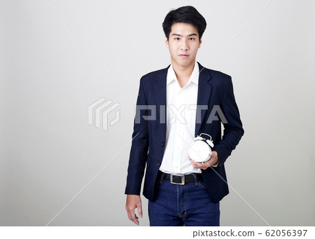Young Thai Businessman Shows Time On Clock Young Thai Businessman Shows Time On Clock 62056397