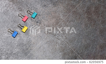 Four binder clips isolated on grey background. Four binder clips isolated on grey background. 62056975