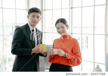 Young couple of professionals chatting during a 62057306