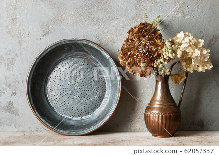 Antique copper sieve on concrete background. Antique copper sieve on concrete background. 62057337