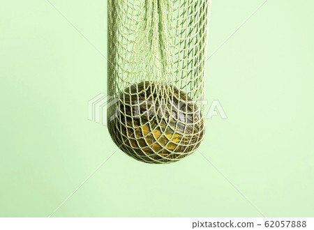 Melon in a green reusable bag. Eco-friendly bag 62057888