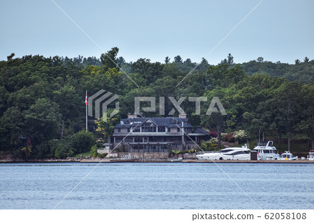 Building in a grassy area on the coast of a lake 62058108
