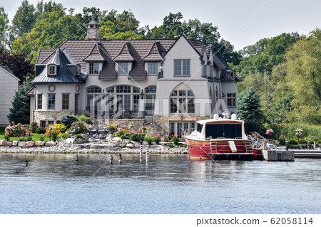 Building in a grassy area on the coast of a lake 62058114