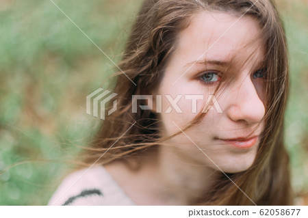 beautiful woman with flowers walking through the green forest in early spring beautiful woman with flowers walking through the green forest in early spring 62058677